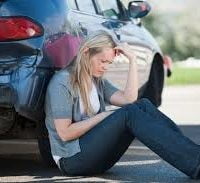 Family checking out damage after car accident